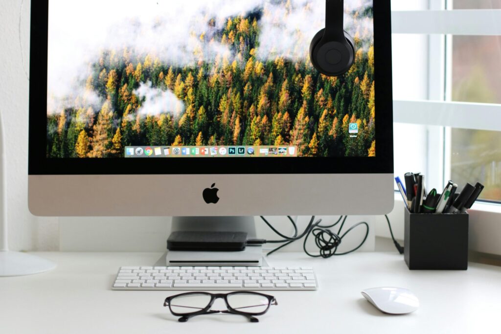Free Stylish home office workspace featuring a computer setup with accessories. Stock Photo